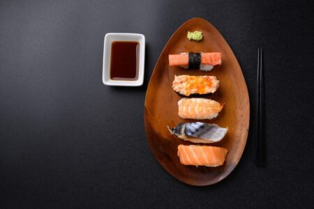 Low carb sushi options including salmon, mackerel, shrimp, and crab nigiri served with soy sauce and wasabi